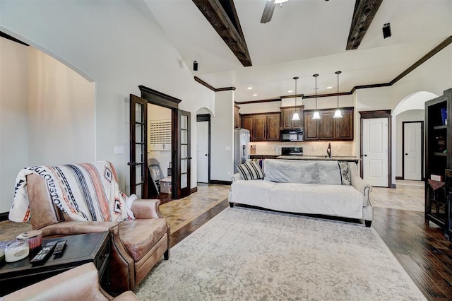 19009 Meadows Crossing Dr, Edmond, OK 73012 - living room with arched walkways, light wood-type flooring, french doors, crown molding, and recessed lighting