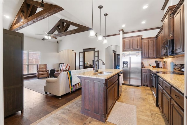 19009 Meadows Crossing Dr, Edmond, OK 73012 - kitchen featuring black appliances, a sink, arched walkways, ceiling fan, and open floor plan