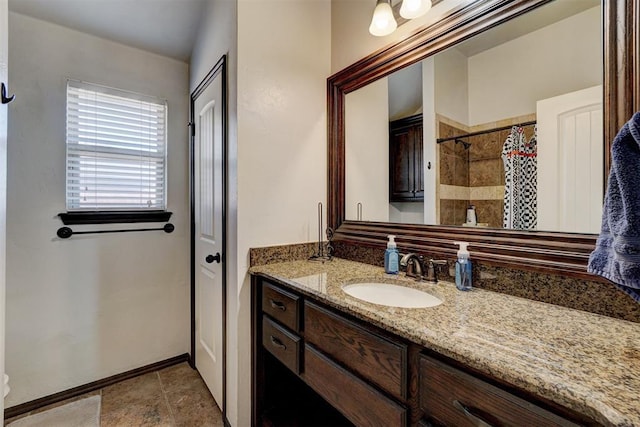 19009 Meadows Crossing Dr, Edmond, OK 73012 - full bathroom with vanity, a tile shower, and baseboards