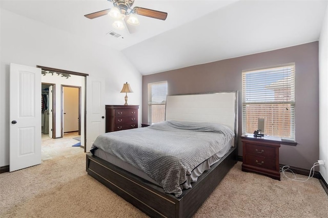 19009 Meadows Crossing Dr, Edmond, OK 73012 - bedroom featuring light carpet, vaulted ceiling, multiple windows, and a ceiling fan