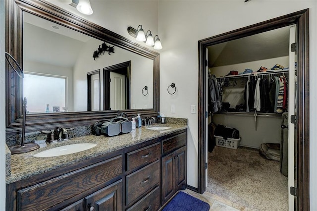 19009 Meadows Crossing Dr, Edmond, OK 73012 - bathroom featuring double vanity, lofted ceiling, and a spacious closet