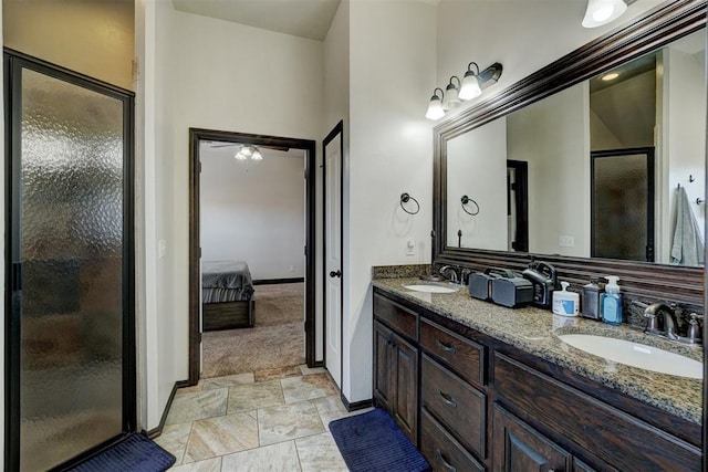 19009 Meadows Crossing Dr, Edmond, OK 73012 - ensuite bathroom featuring a stall shower, double vanity, and baseboards