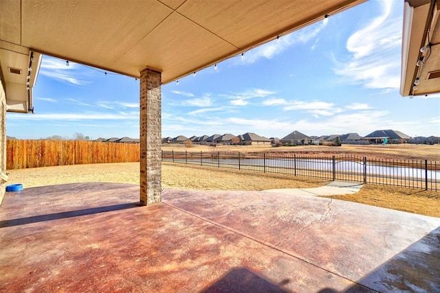 19009 Meadows Crossing Dr, Edmond, OK 73012 - fenced backyard with a patio area, a residential view, and a water view