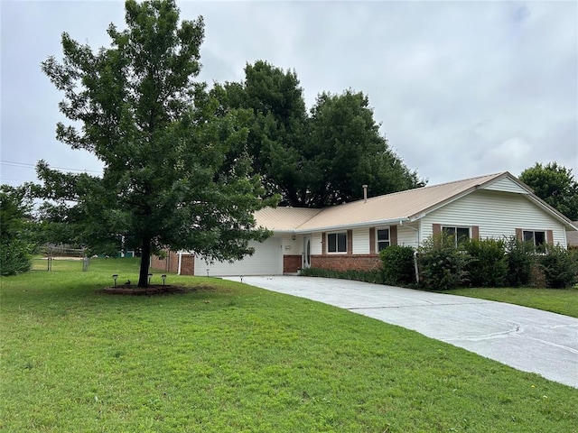 1621 Kings Rd, Edmond, OK 73013 - ranch-style house featuring concrete driveway, a front lawn, a garage, and metal roof