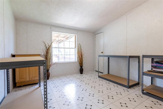 1020 S Walnut Ave, Erick, OK 73645 - unfurnished bedroom featuring a textured ceiling and light floors
