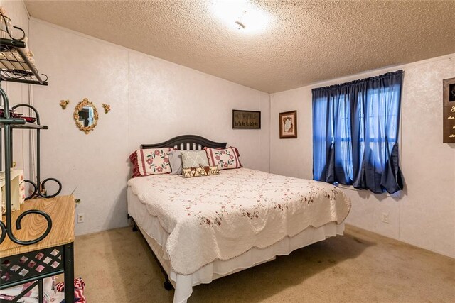 1020 S Walnut Ave, Erick, OK 73645 - bedroom with carpet floors and a textured ceiling