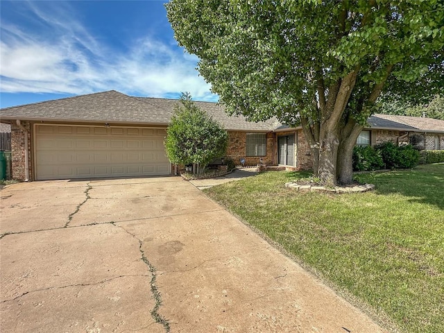 5821 NW 89th St, Oklahoma City, OK 73132 - view of front facade featuring driveway, an attached garage, brick siding, and a front yard