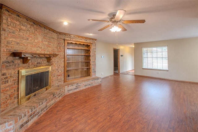 5821 NW 89th St, Oklahoma City, OK 73132 - unfurnished living room with built in features, baseboards, wood finished floors, ceiling fan, and a fireplace