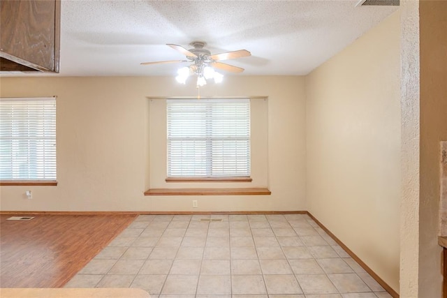 5821 NW 89th St, Oklahoma City, OK 73132 - empty room featuring ceiling fan, plenty of natural light, a textured ceiling, and baseboards