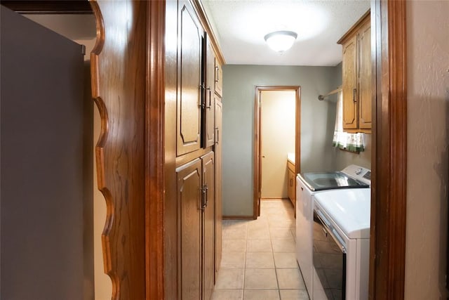 5821 NW 89th St, Oklahoma City, OK 73132 - washroom featuring washer and clothes dryer, cabinet space, and light tile patterned flooring
