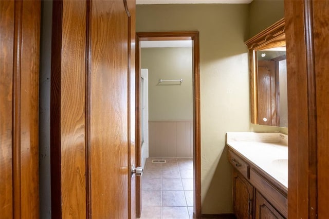 5821 NW 89th St, Oklahoma City, OK 73132 - bathroom with vanity, wainscoting, and tile patterned floors