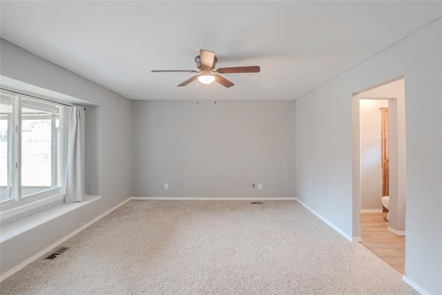 5821 NW 89th St, Oklahoma City, OK 73132 - spare room with ceiling fan, light carpet, and baseboards