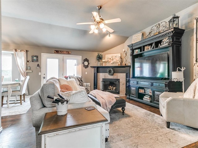 4508 Applegate Dr, Moore, OK 73160 - living room with lofted ceiling, plenty of natural light, a ceiling fan, dark wood finished floors, and a tiled fireplace