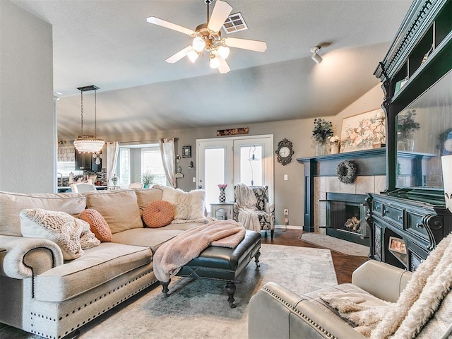 4508 Applegate Dr, Moore, OK 73160 - living area with a ceiling fan, lofted ceiling, a tile fireplace, wood finished floors, and baseboards