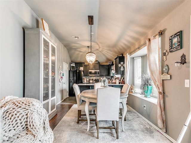 4508 Applegate Dr, Moore, OK 73160 - dining space featuring a chandelier, light wood finished floors, and baseboards
