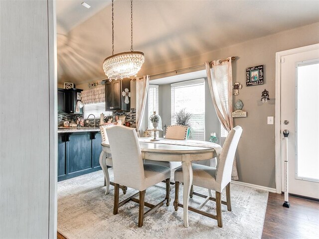 4508 Applegate Dr, Moore, OK 73160 - dining room featuring a chandelier, light wood-type flooring, and baseboards