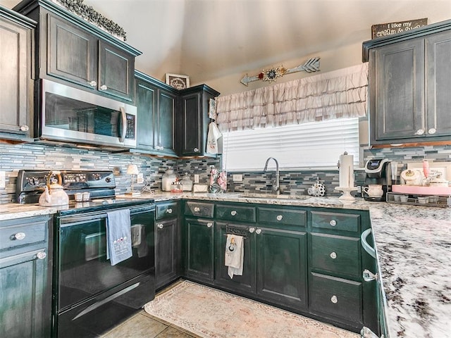 4508 Applegate Dr, Moore, OK 73160 - kitchen with stainless steel microwave, black electric range, a sink, backsplash, and light stone counters