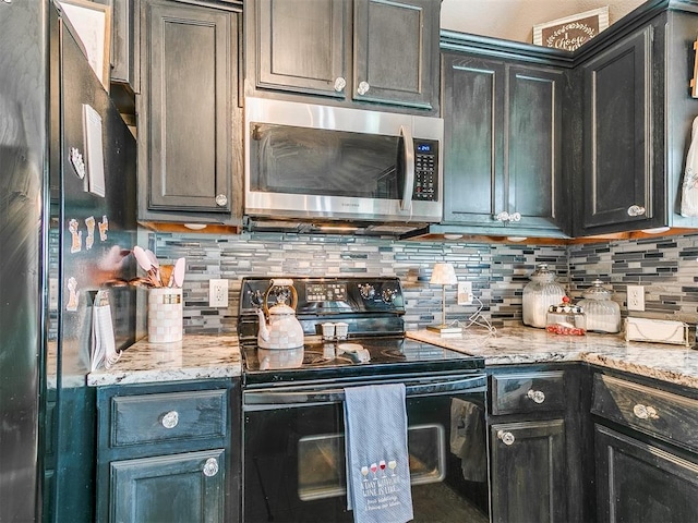 4508 Applegate Dr, Moore, OK 73160 - kitchen featuring black appliances, decorative backsplash, and light stone countertops