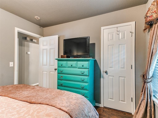 4508 Applegate Dr, Moore, OK 73160 - bedroom with dark wood-style floors and a textured ceiling