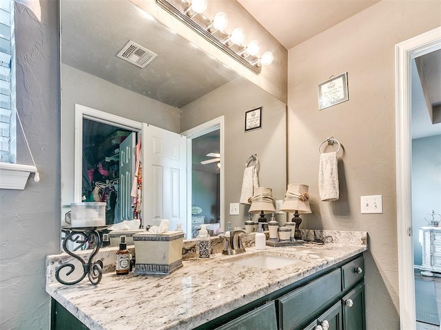 4508 Applegate Dr, Moore, OK 73160 - bathroom with vanity and a textured wall