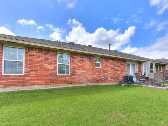 4508 Applegate Dr, Moore, OK 73160 - back of house with a lawn, brick siding, and a patio