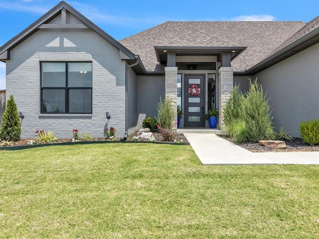 4315 Dusty Trl, Norman, OK 73072 - view of front facade with a front lawn, brick siding, and a shingled roof
