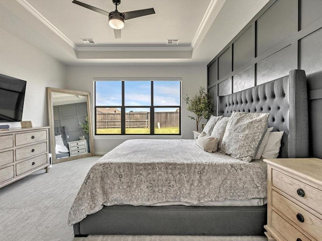 4315 Dusty Trl, Norman, OK 73072 - bedroom featuring a raised ceiling, ornamental molding, light colored carpet, and ceiling fan