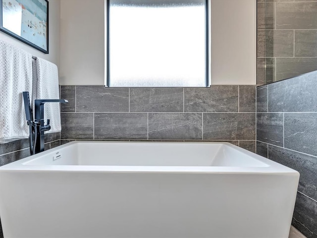 4315 Dusty Trl, Norman, OK 73072 - bathroom with tile walls and a bath