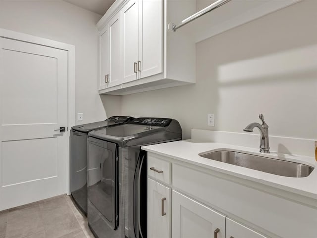 4315 Dusty Trl, Norman, OK 73072 - laundry room featuring washer and dryer, cabinet space, and light tile patterned floors