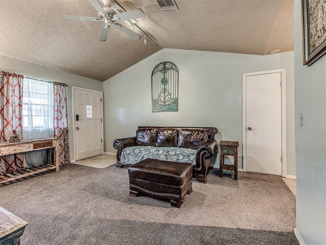 11379 Kirkwin Ln, Choctaw, OK 73020 - carpeted living room featuring a textured ceiling, ceiling fan, vaulted ceiling, and baseboards