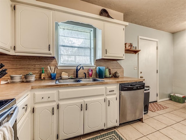 11379 Kirkwin Ln, Choctaw, OK 73020 - kitchen featuring appliances with stainless steel finishes, a sink, decorative backsplash, a textured ceiling, and light tile patterned flooring