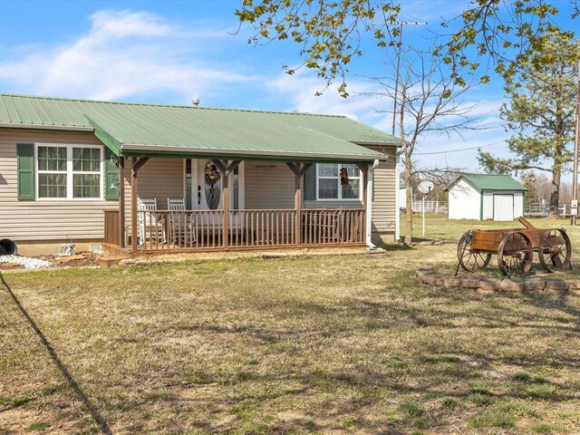 35345 Ew 1240th Rd, Seminole, OK 74868 - view of front facade with a front yard, a porch, metal roof, and an outdoor structure