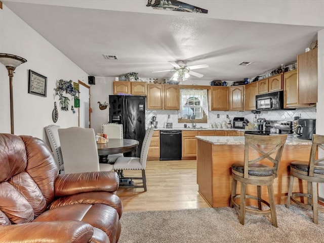 35345 Ew 1240th Rd, Seminole, OK 74868 - kitchen with black appliances, light countertops, backsplash, and light wood-style flooring