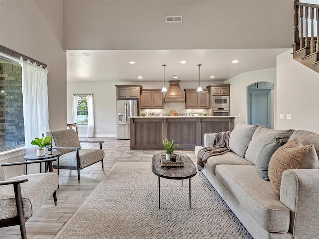 10740 Starboard Way, Edmond, OK 73025 - living area with recessed lighting, a towering ceiling, and arched walkways