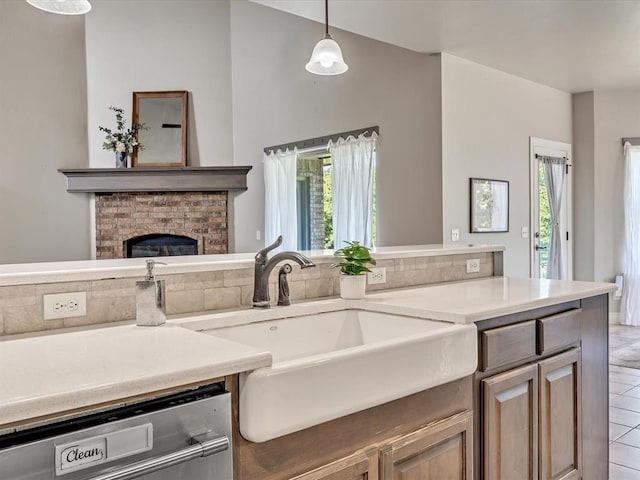 10740 Starboard Way, Edmond, OK 73025 - kitchen with dishwasher, plenty of natural light, a brick fireplace, and light countertops