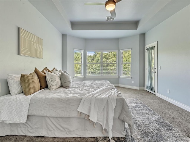 10740 Starboard Way, Edmond, OK 73025 - bedroom featuring carpet flooring, a tray ceiling, and a ceiling fan
