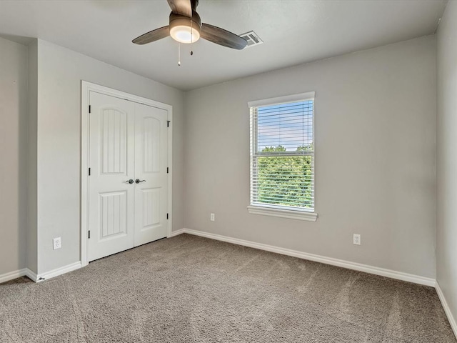 10740 Starboard Way, Edmond, OK 73025 - unfurnished bedroom featuring carpet floors, a closet, and a ceiling fan