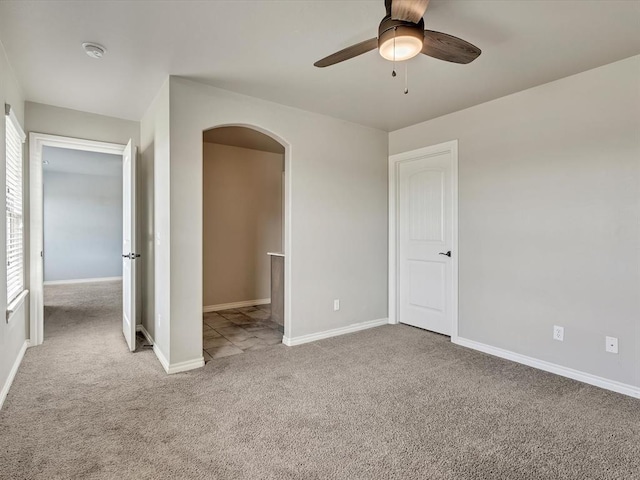 10740 Starboard Way, Edmond, OK 73025 - carpeted spare room featuring arched walkways, ceiling fan, and a smoke detector