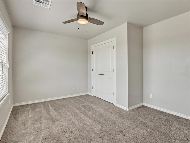 10740 Starboard Way, Edmond, OK 73025 - unfurnished bedroom with carpet, a ceiling fan, and a closet