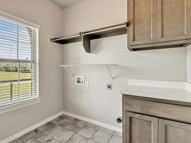 10740 Starboard Way, Edmond, OK 73025 - washroom featuring electric dryer hookup, hookup for a washing machine, and cabinet space