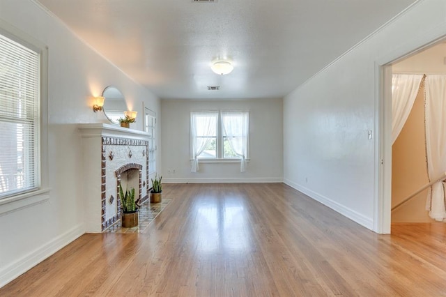 1502 NW 39th St, Oklahoma City, OK 73118 - unfurnished living room featuring a fireplace, wood finished floors, and baseboards