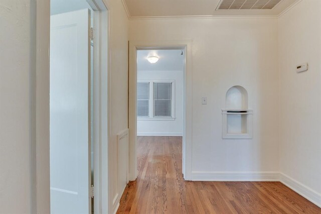 1502 NW 39th St, Oklahoma City, OK 73118 - hall featuring crown molding, wood finished floors, and baseboards