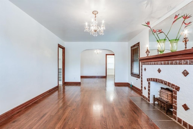 1502 NW 39th St, Oklahoma City, OK 73118 - unfurnished living room with a chandelier, arched walkways, wood finished floors, and baseboards
