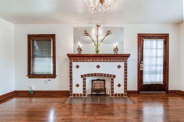 1502 NW 39th St, Oklahoma City, OK 73118 - unfurnished living room featuring wood finished floors, a chandelier, and baseboards