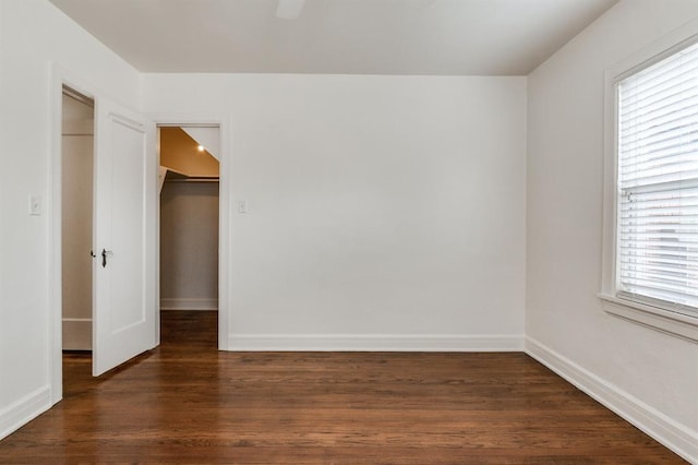1502 NW 39th St, Oklahoma City, OK 73118 - unfurnished bedroom featuring a closet, dark wood finished floors, a walk in closet, and baseboards