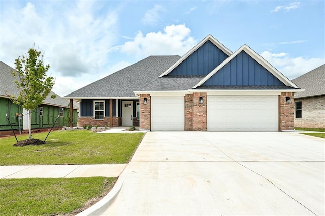 10412 SW 49th St, Mustang, OK 73064 - craftsman-style home with board and batten siding, a garage, brick siding, concrete driveway, and a front lawn