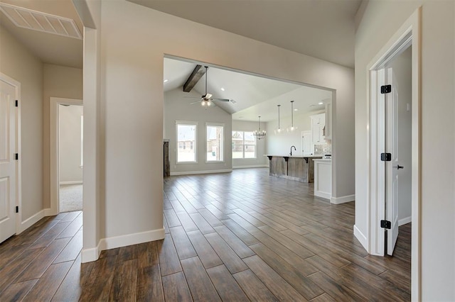 10412 SW 49th St, Mustang, OK 73064 - unfurnished living room with a ceiling fan, dark wood-style flooring, baseboards, and a sink