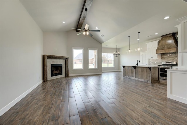 10412 SW 49th St, Mustang, OK 73064 - unfurnished living room featuring beamed ceiling, a ceiling fan, a tile fireplace, dark wood-style flooring, and baseboards