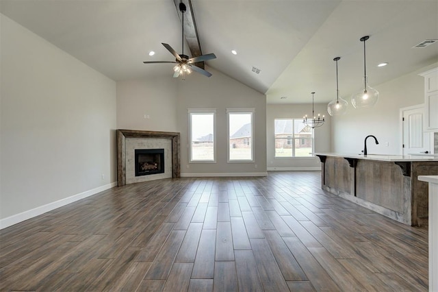 10412 SW 49th St, Mustang, OK 73064 - unfurnished living room with a ceiling fan, beam ceiling, a chandelier, a fireplace, and dark wood finished floors