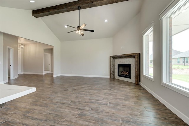 10412 SW 49th St, Mustang, OK 73064 - unfurnished living room with a ceiling fan, beamed ceiling, a fireplace, wood finished floors, and baseboards